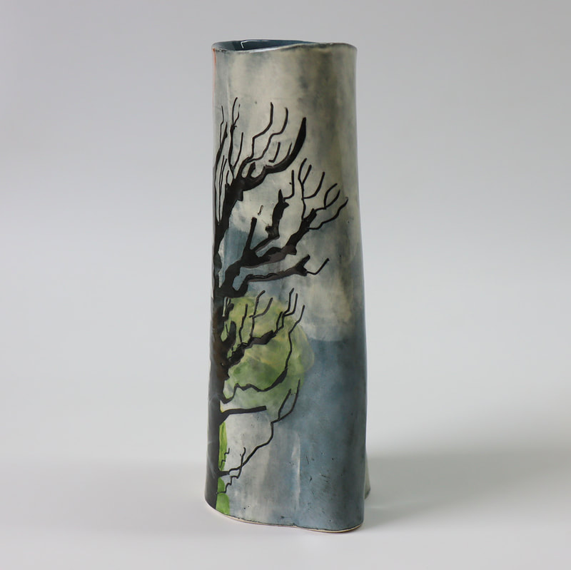 ceramic bottle painted to depict apple trees