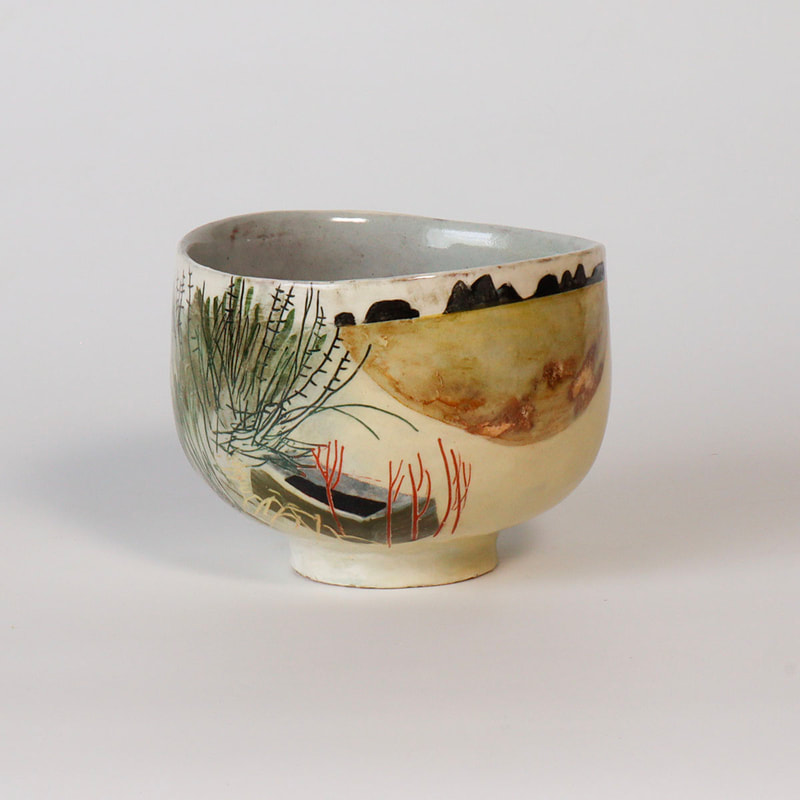 small ceramic bowl painted with slips, depicting a Devon hedge and water trough.