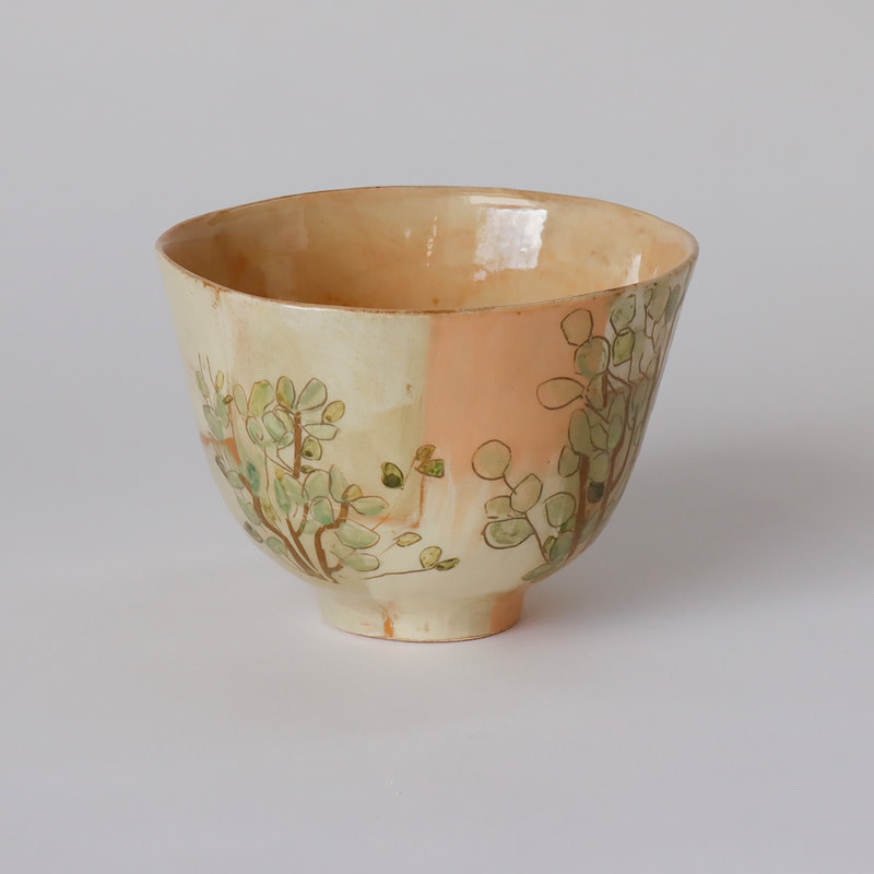 ceramic cup slip painted with alders (not hazels as originally thought).