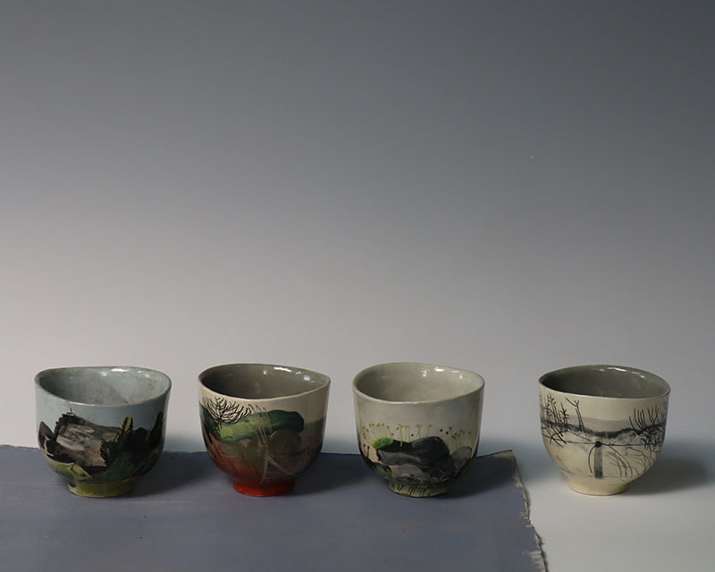 small ceramic bowls slip painted to illustrate old overgrown sea walls in south Devon
